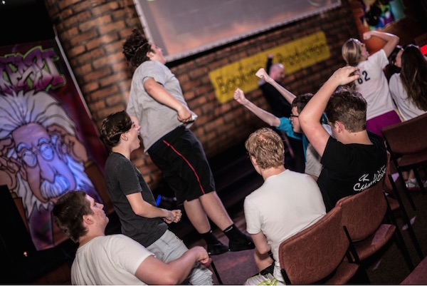 Students jump with excitement at a ThinkFast event.