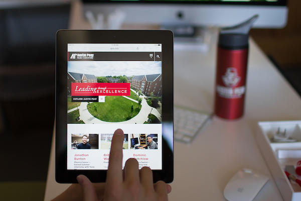 The new APSU website appears on a tablet, showing off its responsive design