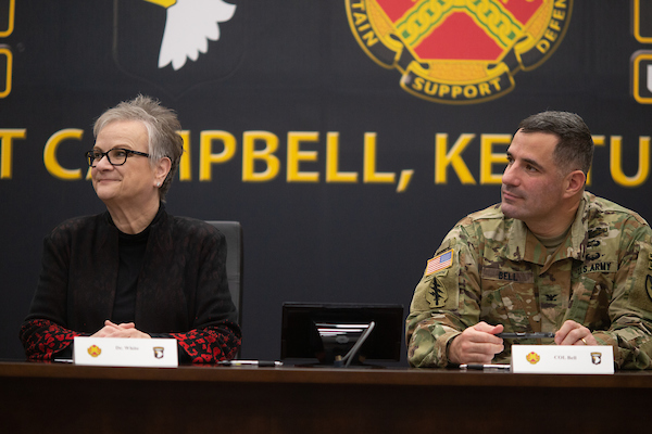 President White and Col. Bell sit at a table.