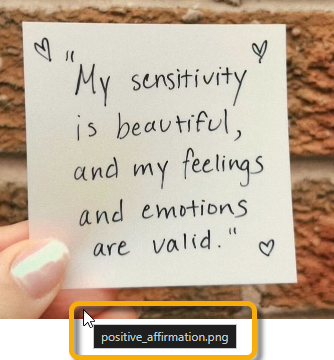 Screenshot of a hand holding a post-it with the alternative text 'positive_affirmation.png' highlighted
