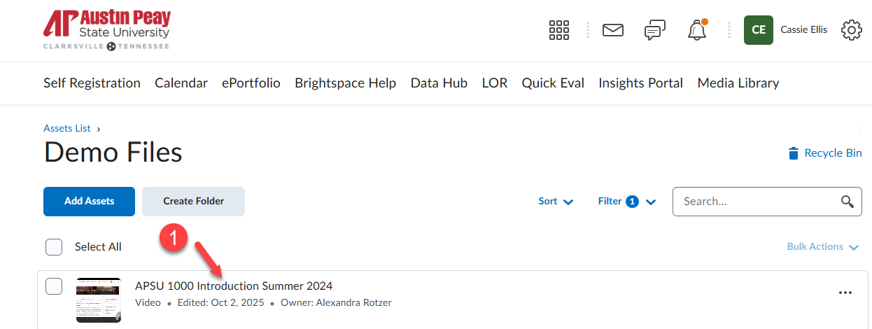 A screenshot of step 1 with a red arrow pointing to the video in media library to open