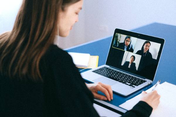 woman in front of laptop hosting a web meeting