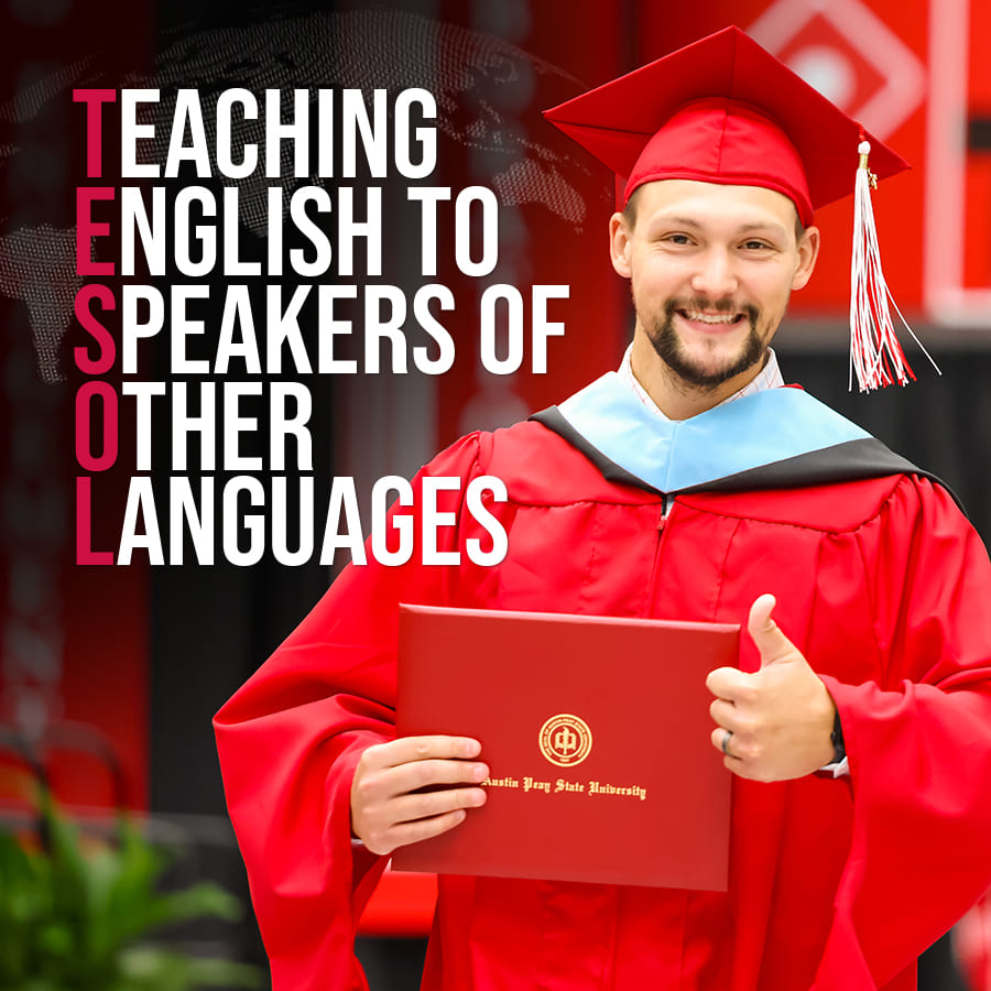 Male graduate in red regalia smiling and giving a thumbs up to the camera while holding his diploma.