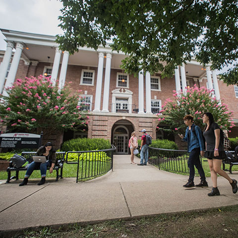 Students walk by Harned hall