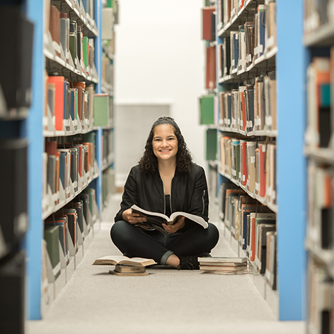 Natalie Castillo sits in library