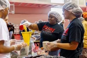 Workers prepare meal bags.