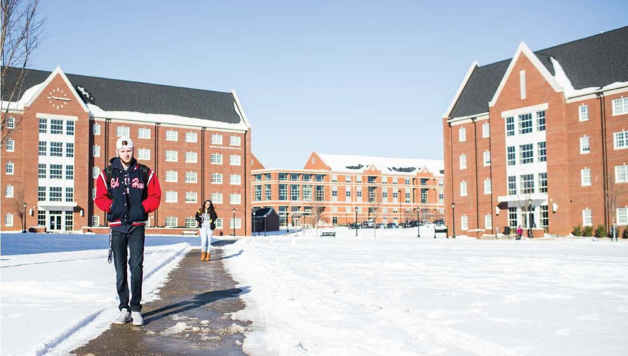 students walk through snowy campus