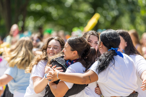 Group of students hugging on bid day